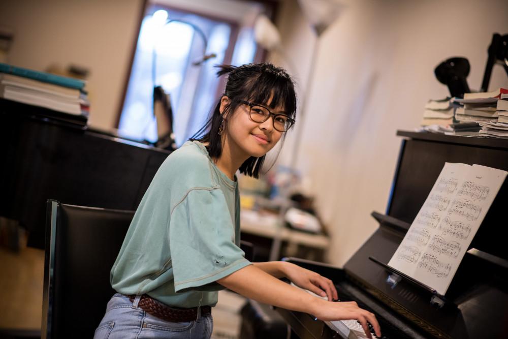 Student plays piano in the recording studio at CELEB.